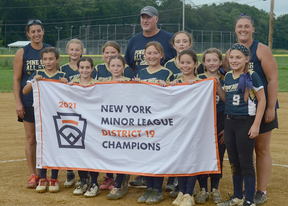 The Pine Bush Minors softball team poses with the championship banner after beating Chester, 5-4, on Friday at Pine Bush Town Park.